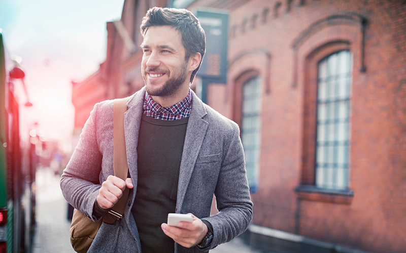 Business man walking through a city